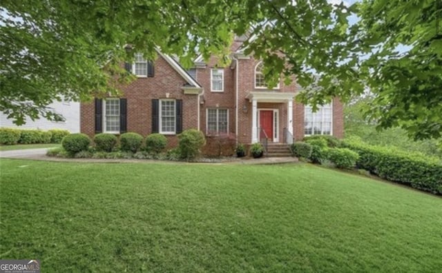 colonial home featuring a front yard