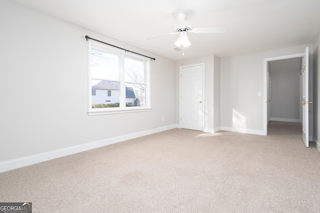 unfurnished bedroom featuring ceiling fan and carpet