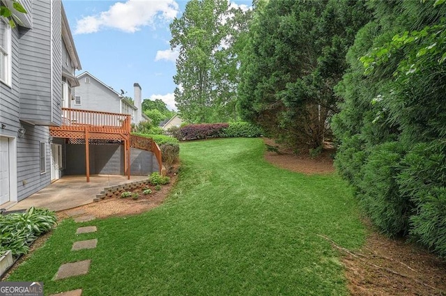 view of yard featuring a deck and a patio area