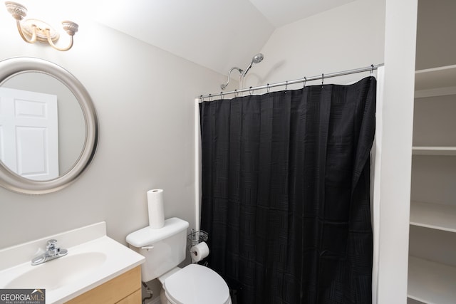 bathroom featuring a shower with shower curtain, vanity, toilet, and lofted ceiling