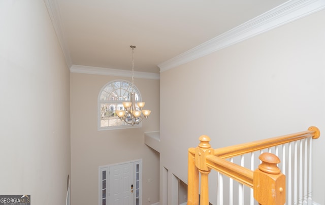 stairway with crown molding and a notable chandelier