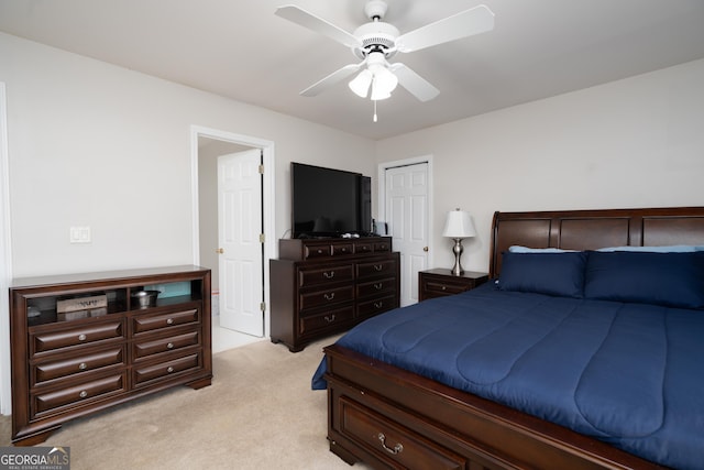 carpeted bedroom with a closet and ceiling fan