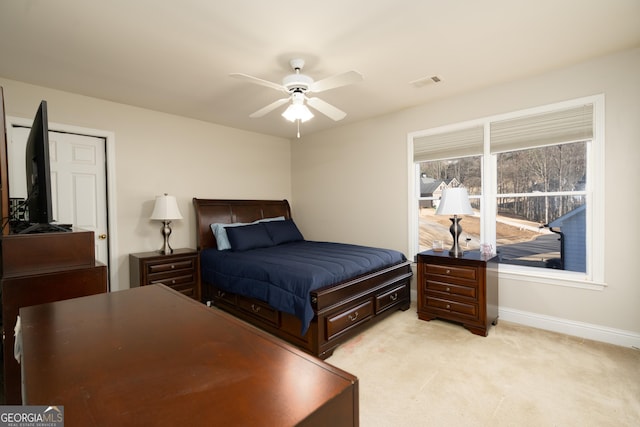 bedroom featuring ceiling fan and light colored carpet