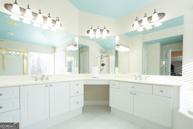 bathroom with a healthy amount of sunlight, vaulted ceiling, vanity, and walk in shower