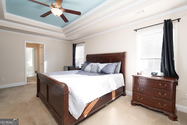 carpeted bedroom with ornamental molding, connected bathroom, ceiling fan, and a raised ceiling