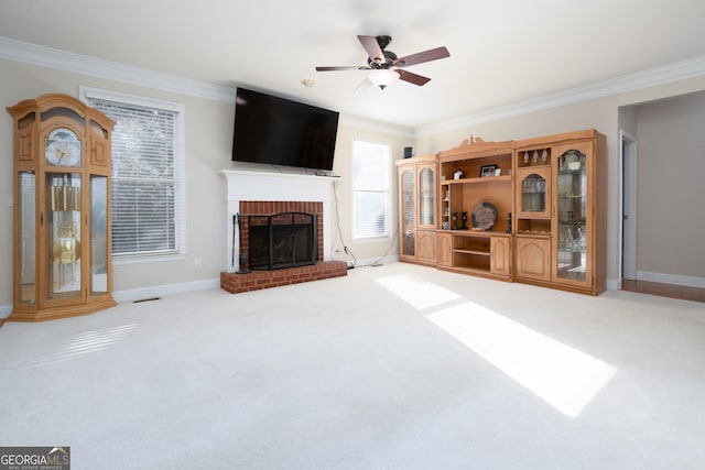 unfurnished living room featuring a fireplace, crown molding, carpet, and ceiling fan