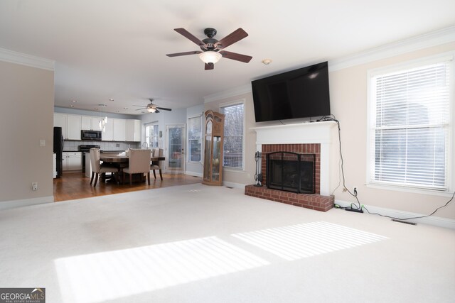 living room featuring a fireplace and crown molding