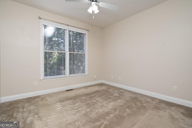 unfurnished room featuring carpet and ceiling fan