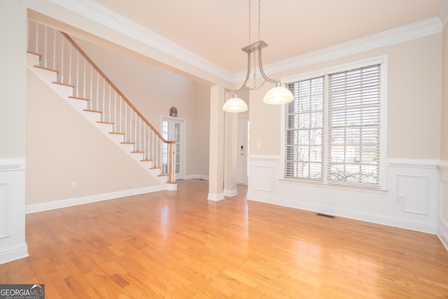 unfurnished dining area featuring hardwood / wood-style flooring and ornamental molding