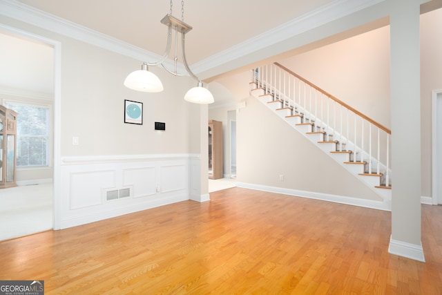 unfurnished dining area with hardwood / wood-style flooring and crown molding