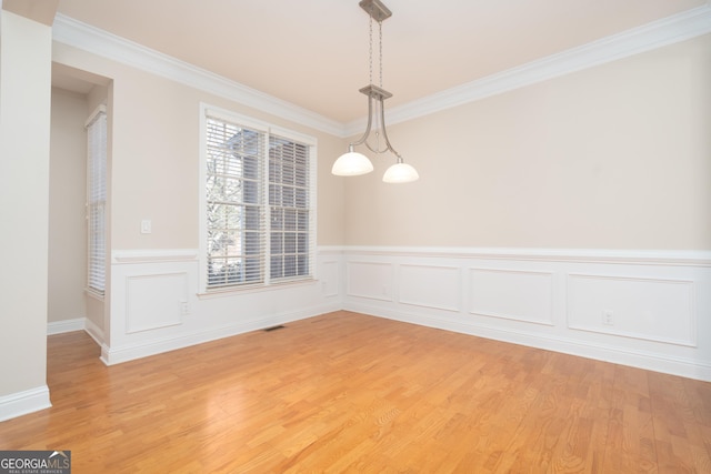 unfurnished dining area with hardwood / wood-style flooring and crown molding