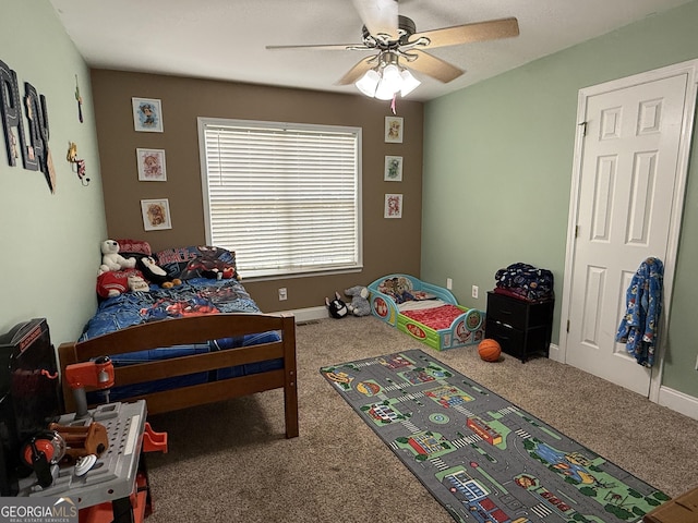 carpeted bedroom featuring ceiling fan