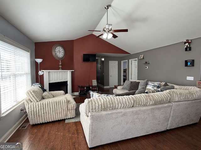 living room featuring vaulted ceiling, dark hardwood / wood-style floors, and ceiling fan