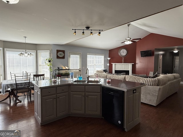 kitchen featuring sink, hanging light fixtures, dark hardwood / wood-style floors, black dishwasher, and a center island with sink