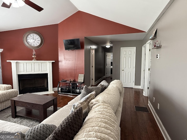 living room with hardwood / wood-style flooring, lofted ceiling, and ceiling fan