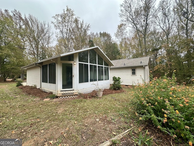 rear view of property with a lawn