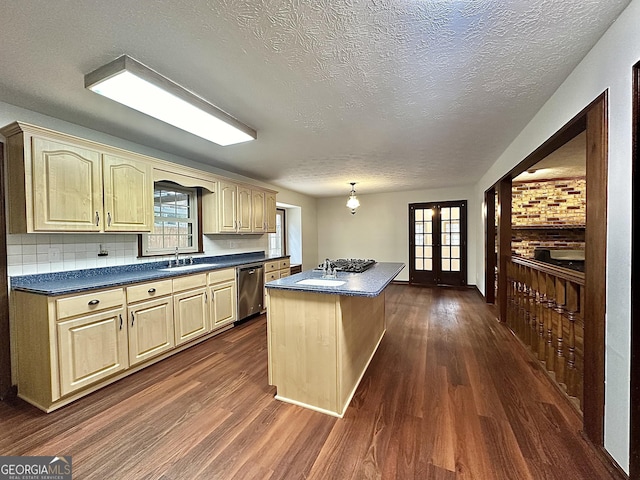 kitchen with a center island, stainless steel dishwasher, dark hardwood / wood-style floors, and french doors