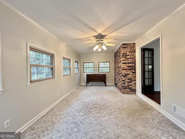 unfurnished bedroom featuring crown molding, ceiling fan, light carpet, and a textured ceiling