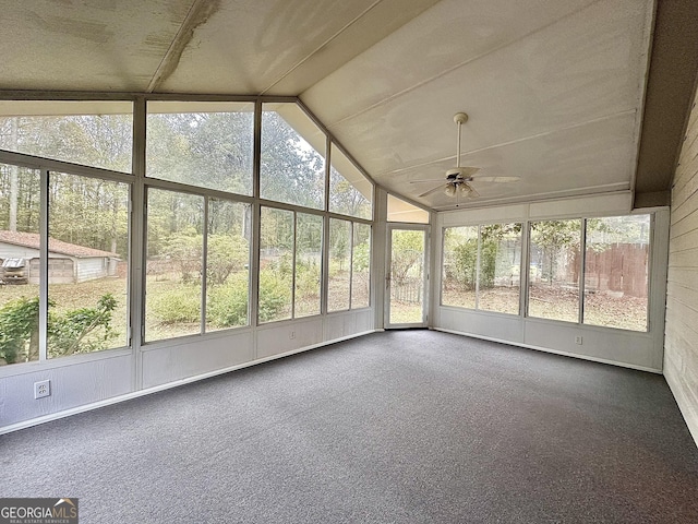 unfurnished sunroom with ceiling fan, a healthy amount of sunlight, and vaulted ceiling