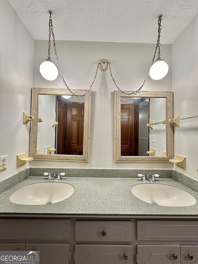 bathroom featuring vanity and a textured ceiling