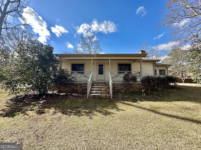 view of front of house with a front yard and a porch