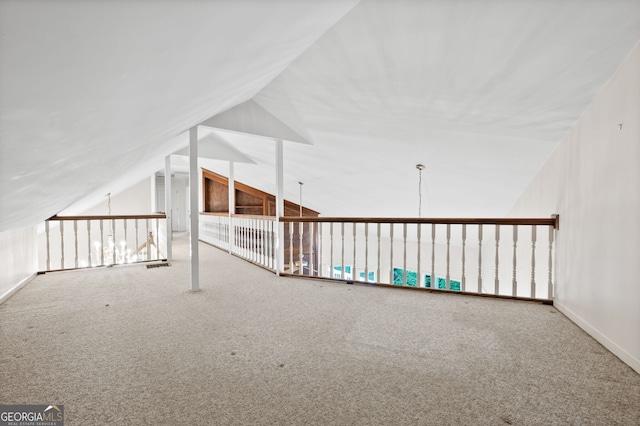 bonus room with lofted ceiling and carpet