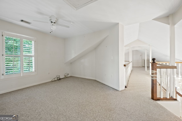 bonus room with ceiling fan and light carpet