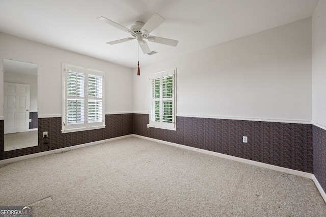 carpeted empty room featuring ceiling fan