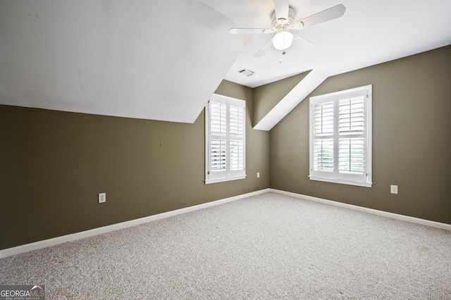 bonus room with ceiling fan, lofted ceiling, and carpet