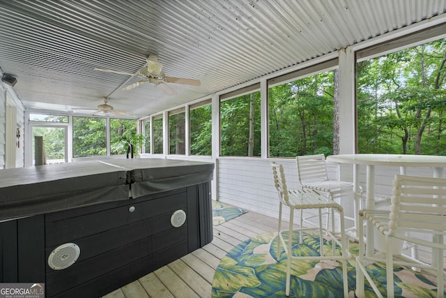 wooden deck featuring a hot tub and ceiling fan