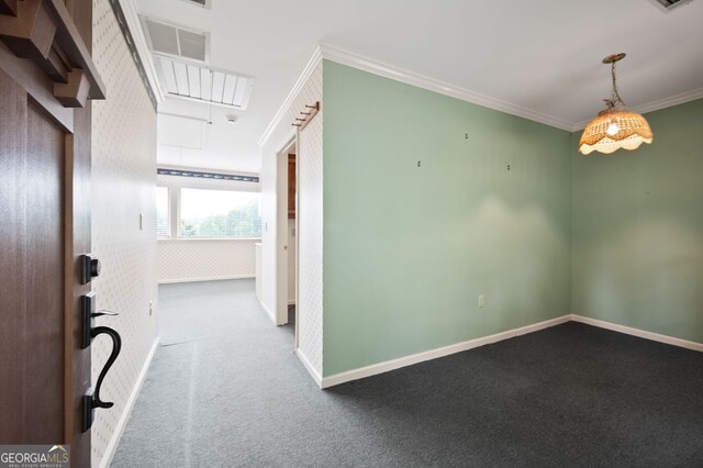 unfurnished room featuring ornamental molding and carpet