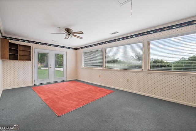 carpeted spare room with ornamental molding, ceiling fan, and french doors