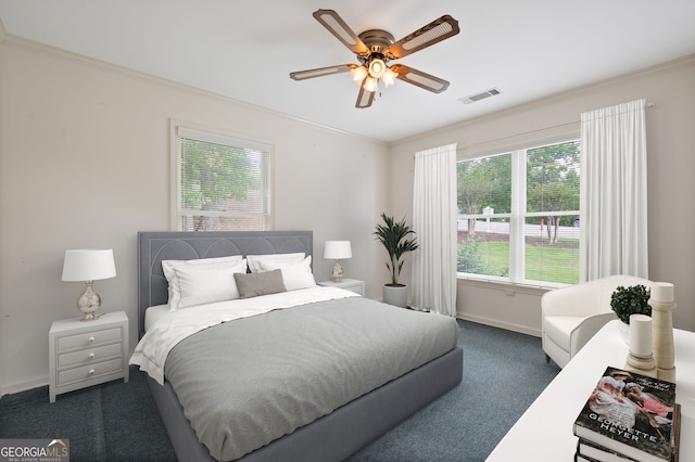 carpeted bedroom featuring ornamental molding and ceiling fan