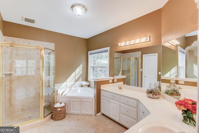 bathroom featuring tile patterned floors, vanity, and plus walk in shower