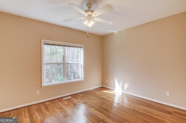 spare room featuring ceiling fan and light hardwood / wood-style flooring