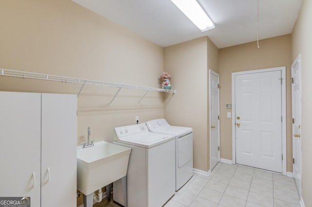 laundry area featuring separate washer and dryer, light tile patterned floors, and sink