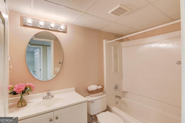 full bathroom with vanity, bathtub / shower combination, a drop ceiling, and toilet