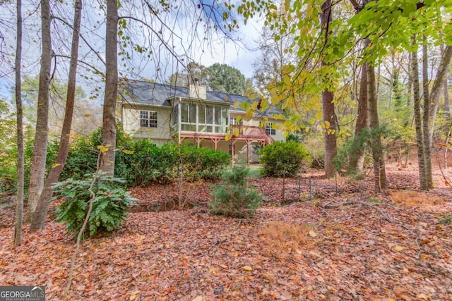 view of yard with a sunroom and a deck