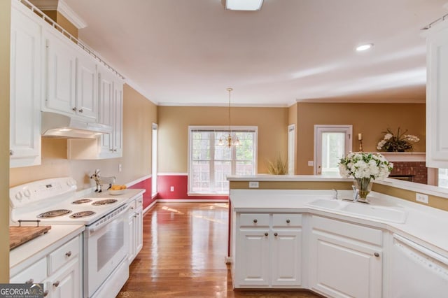 kitchen featuring sink, white cabinets, hanging light fixtures, white appliances, and light hardwood / wood-style flooring