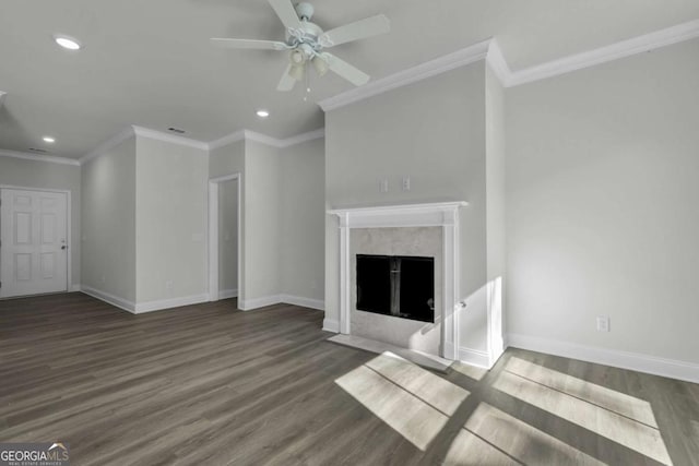 unfurnished living room featuring a premium fireplace, ornamental molding, ceiling fan, and dark hardwood / wood-style flooring