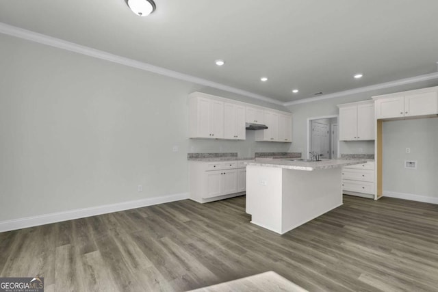 kitchen with crown molding, dark hardwood / wood-style floors, a kitchen island with sink, and white cabinets