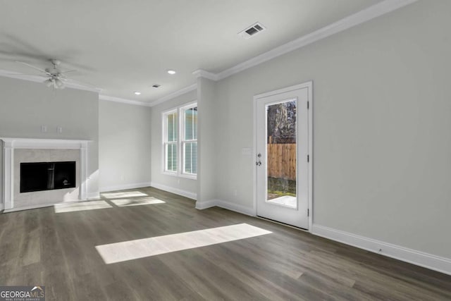 unfurnished living room featuring ceiling fan, ornamental molding, a premium fireplace, and dark hardwood / wood-style flooring