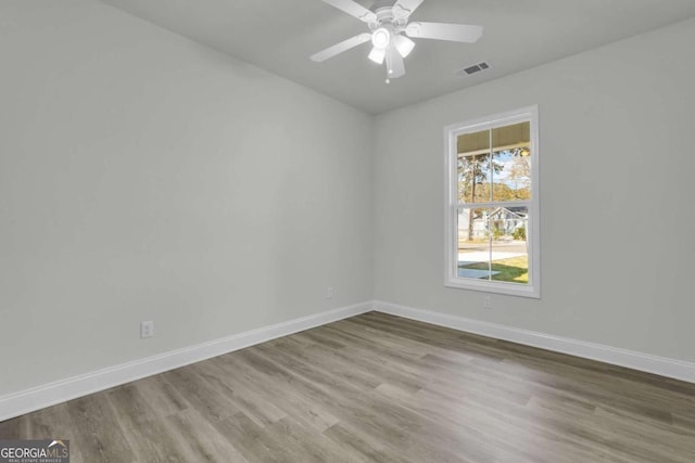 spare room with hardwood / wood-style flooring and ceiling fan