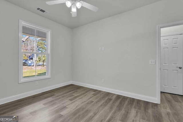 empty room with hardwood / wood-style flooring and ceiling fan