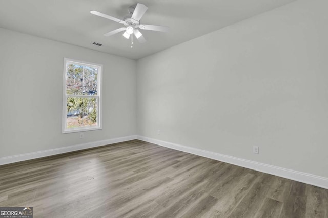 spare room featuring hardwood / wood-style floors and ceiling fan