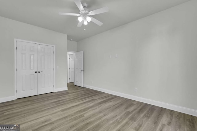 unfurnished bedroom with a closet, ceiling fan, and light hardwood / wood-style flooring