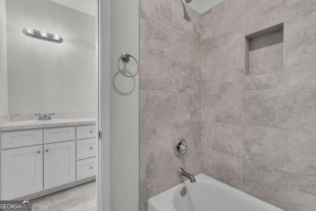 bathroom with vanity and tiled shower / bath combo