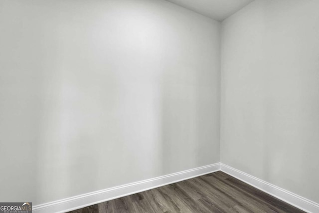 spare room featuring dark hardwood / wood-style floors