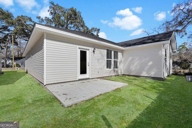 back of property featuring a patio area and a lawn