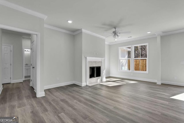 unfurnished living room with crown molding, ceiling fan, a high end fireplace, and light wood-type flooring